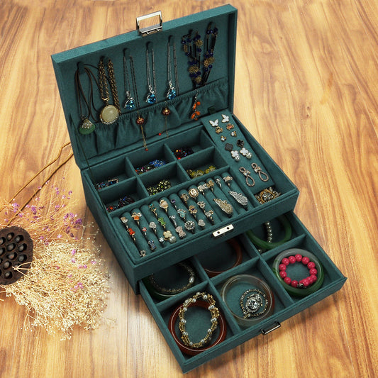 A wooden jewelry box with a watch and bracelet inside.